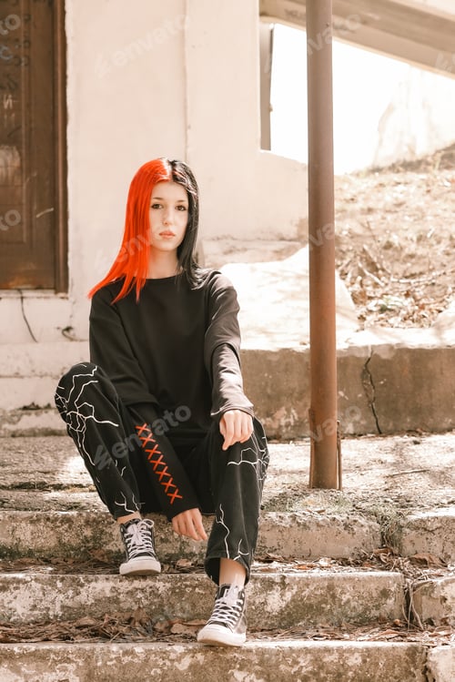 Preview: A young girl is sitting on a stone staircase