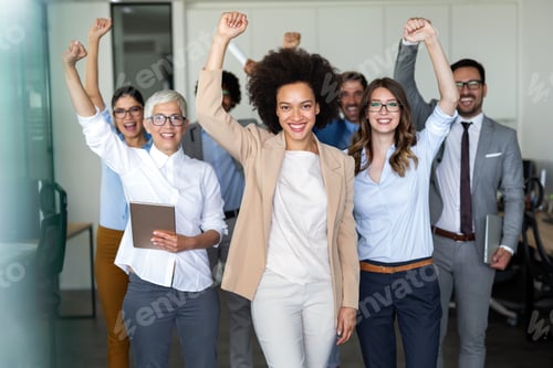 Preview: Group of successful multiethnic business people celebrating a good job in the office