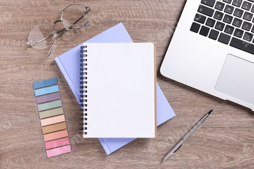 Preview: Blank notebooks, laptop, glasses and stationery on wooden table, flat lay