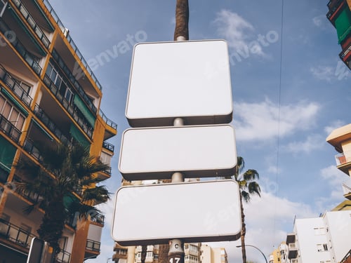 Preview: Low angle shot of white blank billboards on the street