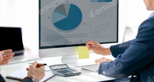 Preview: Two business teamwork calculating a business valuation in workplace, analyzing graph chart.