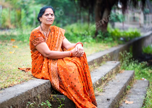 Preview: Happy Indian woman in traditional clothes at outdoor.