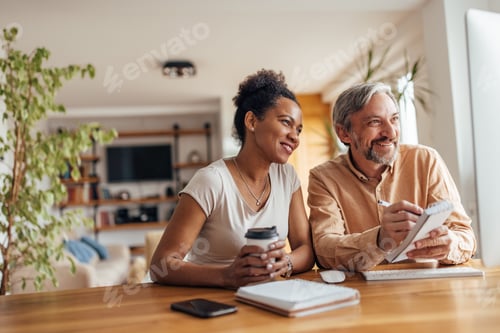 Preview: Smiling Adults Working Together at Home Office