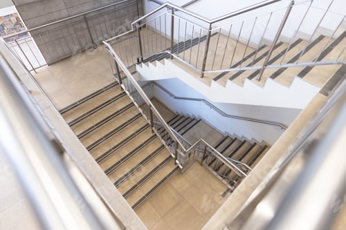 Preview: Empty room with stairs and silver banister in modern office