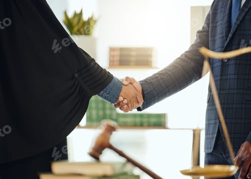 Preview: Lets fight injustice together. Shot of two unrecognizable lawyers shaking hands at work.
