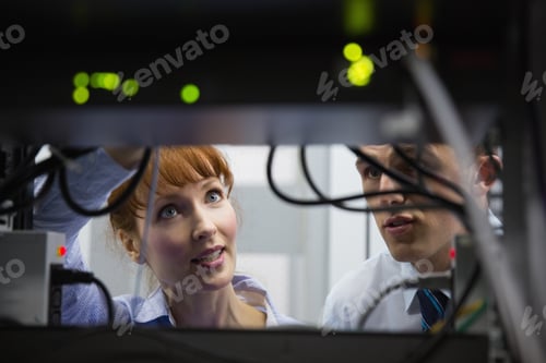 Preview: Team Of Technicians Talking And Looking At Server In Large Data Center