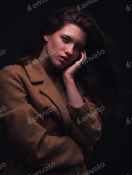 Preview: Sexy And Beautiful Young Woman Looking At Camera, Posing In Amber Coat, Same Color As Her Skin