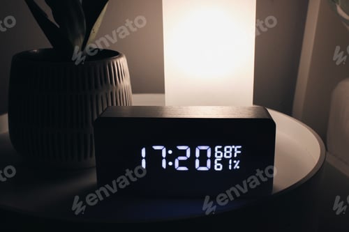 Preview: Minimalistic alarm clock on white bedside table