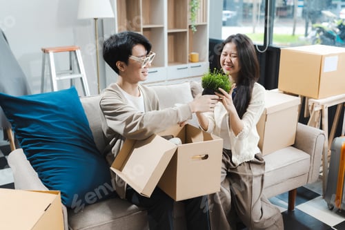 Preview: Young couple relaxing very happy moving to a new house.