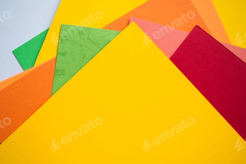 Preview: Multicolored paper with yellow paper top view. flat lay or top view with copy space.