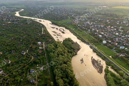 Preview: Aerial landscape of small town or village with rows of residential homes and green trees and big