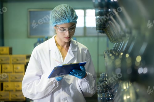 Preview: Female researcher carrying out scientific research in drinking water factory