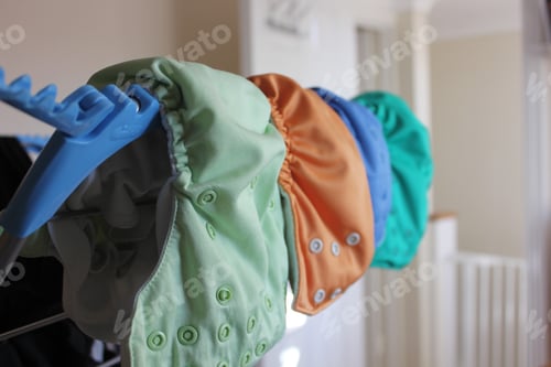 Preview: Eco friendly reusable diapers hanging on drying rack