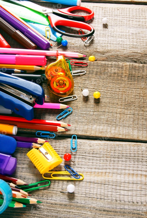 Preview: School tools. On wooden background.