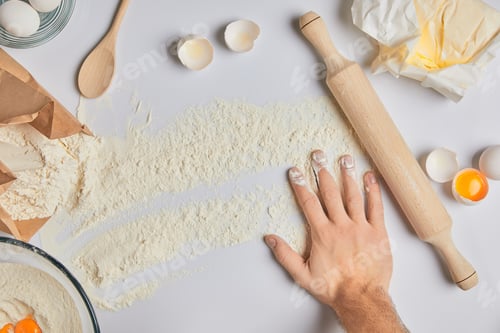 Preview: cropped image of chef putting hand on table with flour