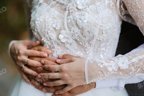 Preview: the bride and groom tenderly hold hands between them love and relationships