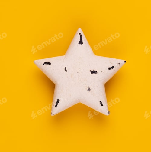 Preview: Christmas star decor on yellow colored background.
