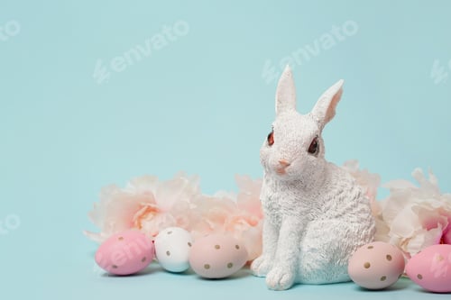 Preview: Happy Easter. Congratulatory blue Easter background with bunny, eggs and flowers, copy space
