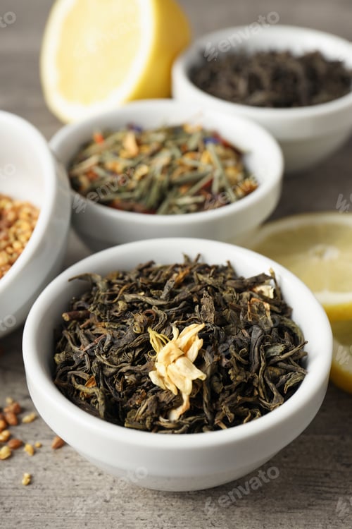 Preview: Concept of cooking tea with different types of tea on gray wooden background