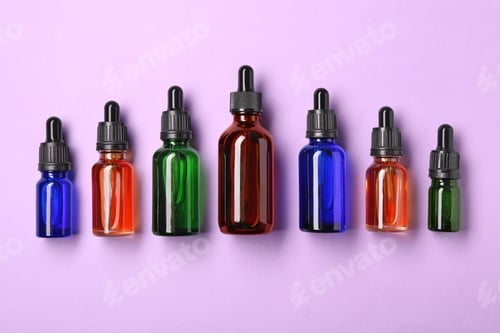 Preview: Bottles of essential oils on color background, flat lay. Cosmetic products