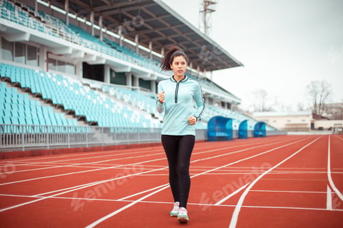Preview: Beautiful girl at the stadium. Sports girl in a sportswear