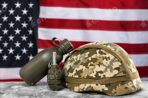Preview: Military canteen, helmet and grenade on table against American flag background