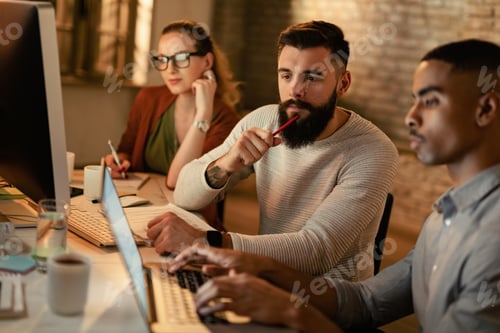 Preview: Young coworkers making business plans on laptop in the office.