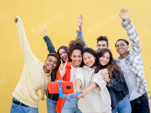 Preview: Group of diverse millennials recording a video or taking a photo for social media.