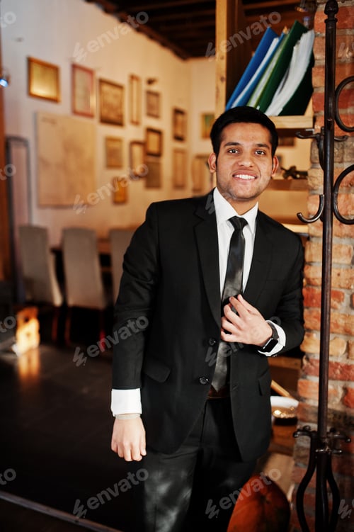 Preview: Elegant south asian indian business man in black suit.