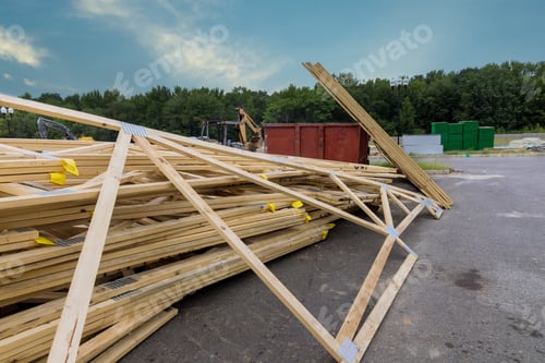 Preview: Stack of lumber wooden beams prepared to build a house in joinery of boards wood frame construction