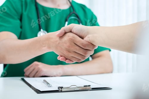 Preview: Good collaboration, Doctor and patient shaking hands after a good and successful treatment