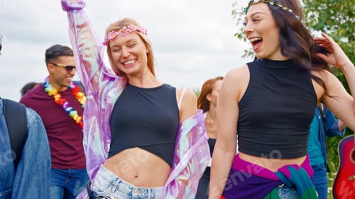 Preview: Group Of Excited Young Friends Carrying Camping Equipment Through Field To Music Festival