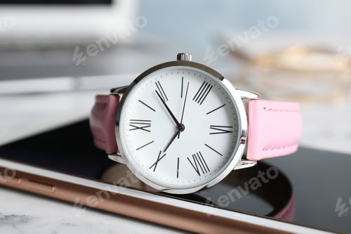 Preview: Stylish wrist watch with modern smartphone on marble table. Fashion accessory