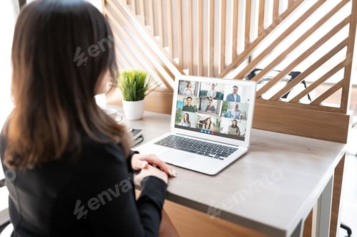 Preview: Business woman having a video conference on her laptop