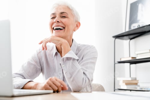 Preview: Happy Caucasian mature businesswoman winning money laughing at workplace.