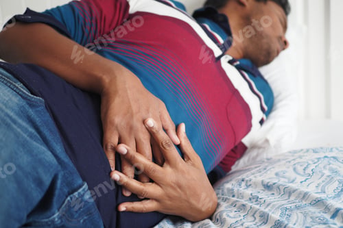 Preview: young man suffering stomach pain close up.
