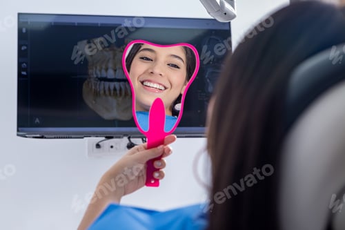 Preview: Happy teenager admiring teeth in mirror