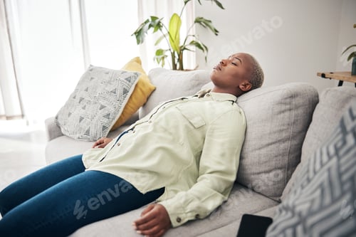 Preview: Tired, sleep and black woman on a home sofa for relax, stress relief or lazy after work. Mental hea