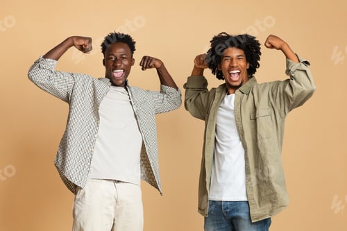 Preview: Two Cheerful Black Guys Raising Fists, Showing Biceps At Camera