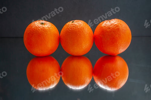 Preview: Top view of fresh oranges standing side by side on black background with free space