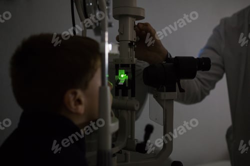Preview: Optician testing a boy's eyes