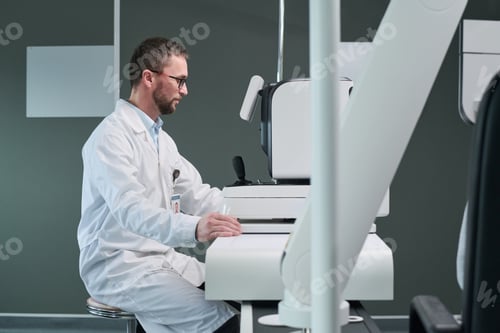 Preview: Middle Aged Man Operating Medical Imaging Equipment