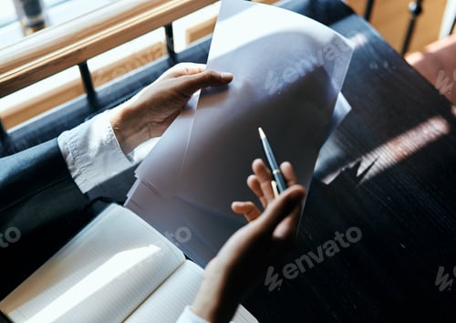Preview: A business man in a suit is sitting in a cafe or with a laptop the work is an official