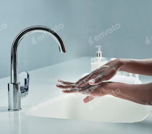Preview: Clean it like you mean it. Cropped shot of a man washing his hands in a bathroom sink.