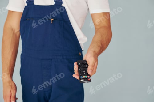 Preview: Close up view of male worker in blue uniform that standing inside of studio