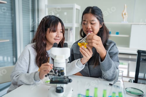 Preview: Young asian schoolgirls learning in chemistry classroom.