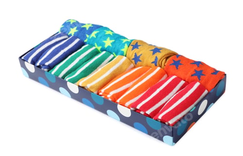 Preview: Box with cute child socks on white background
