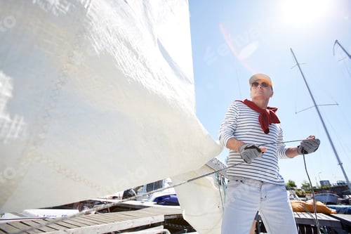 Preview: Sailor releasing sail in sunlight
