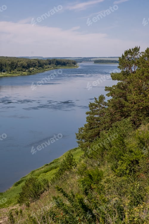 Preview: Beautiful, wide autumn river among forests and rocky shore.