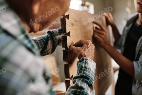 Preview: Carpenter examining wooden board